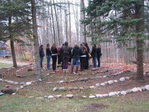 A group of students stand in the middle of the new Orillia Campus labyrinth