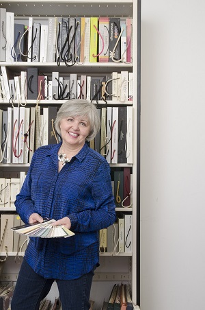Female professor holding up paint swatches in a design library