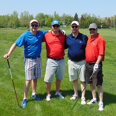 four men standing at a golf course at the 2018 Georgian Golf Classic