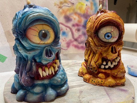 Two colourful cyclops monster sculptures.