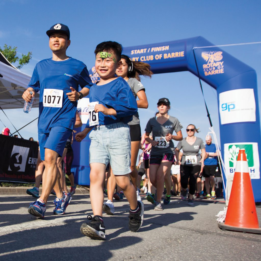 Adult and child running in the Rotary Fun Run