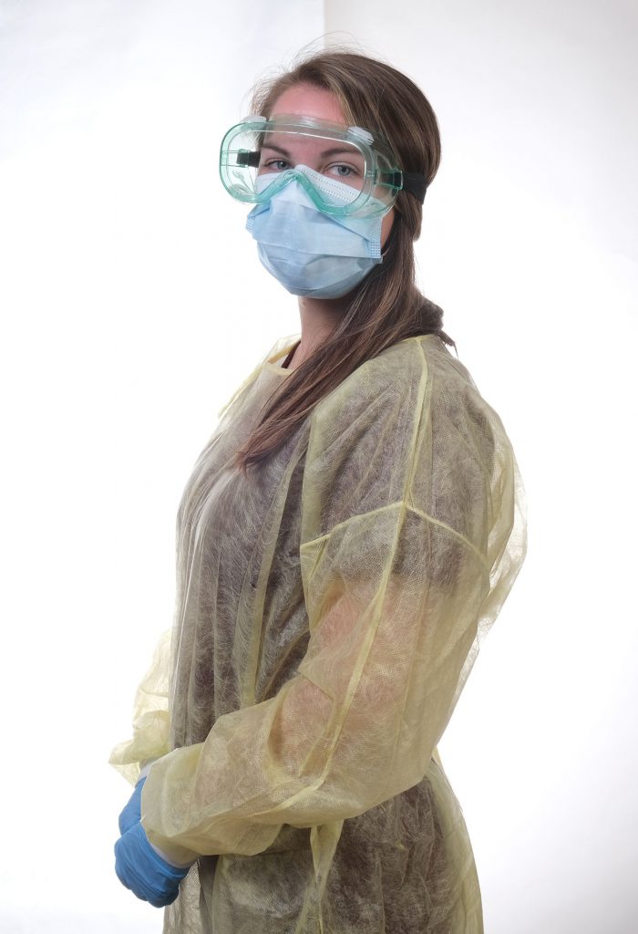 A female wearing a blue face mask and yellow covering