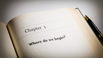 "Chapter 1 Where do we begin" written on the pages of a book.