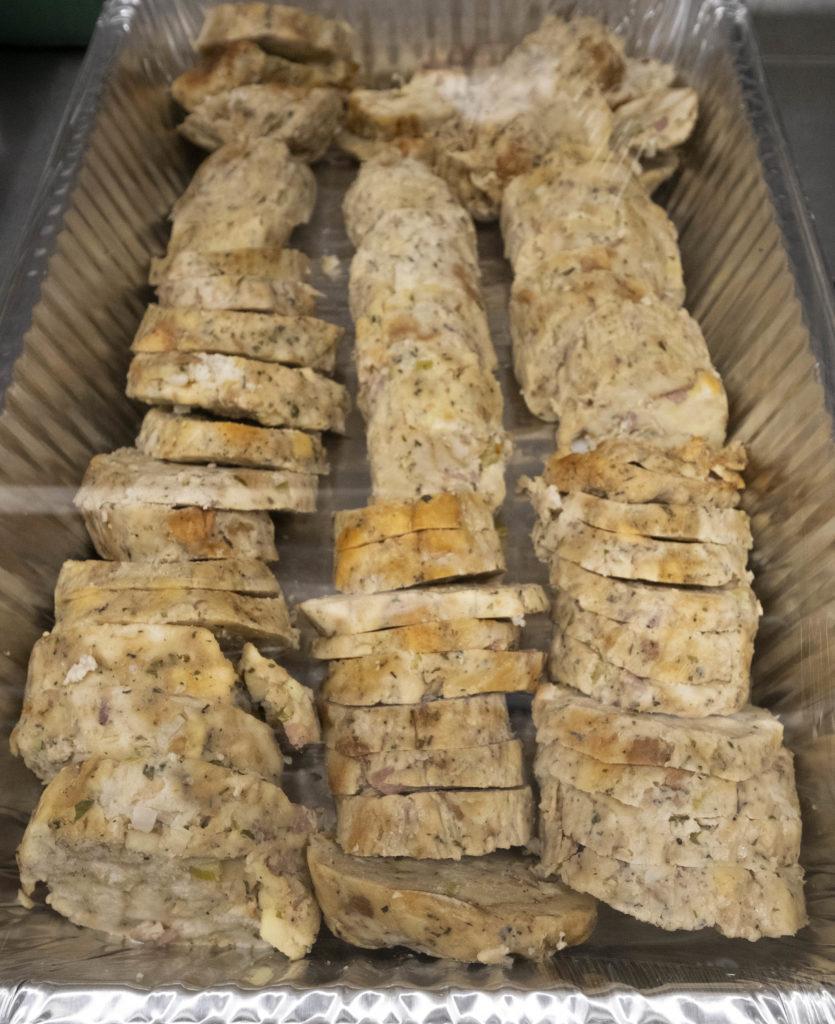 A pan filled with three rows of dressing cut in slices