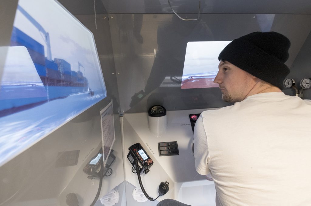 student navigating a ship in a marine simulator