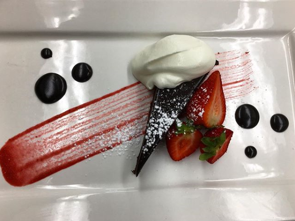Dark chocolate torte with strawberries and chantilly cream