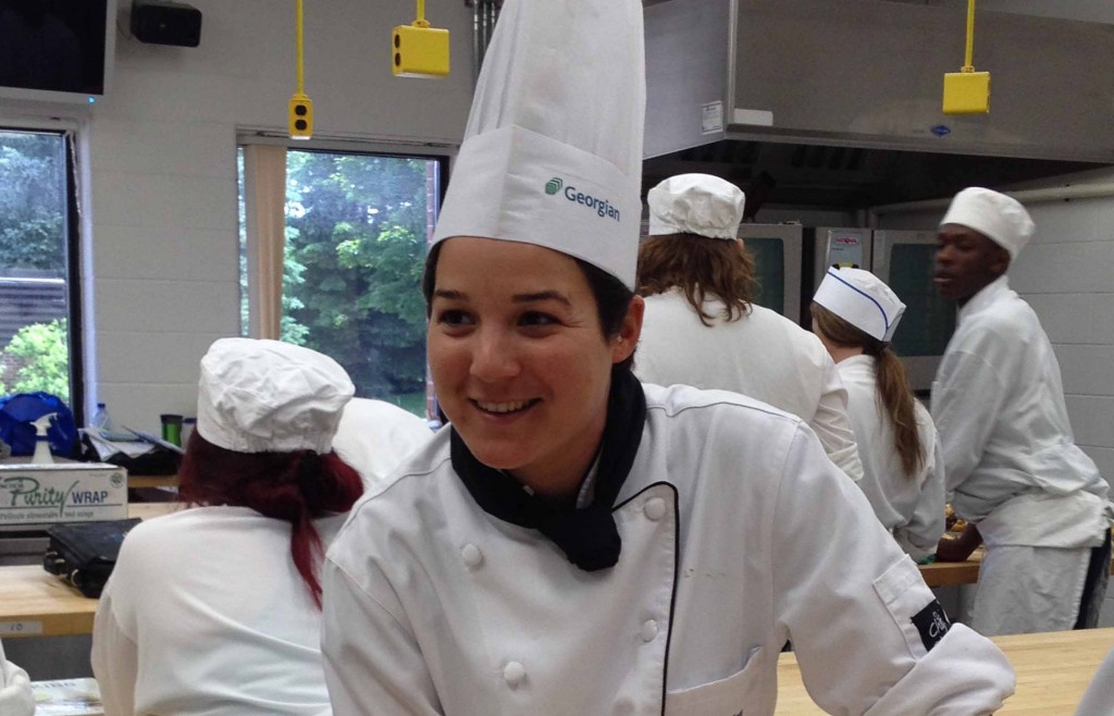 A young girl in white chef's uniform.