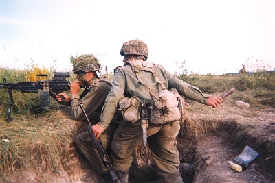 Two people in uniform training for combat