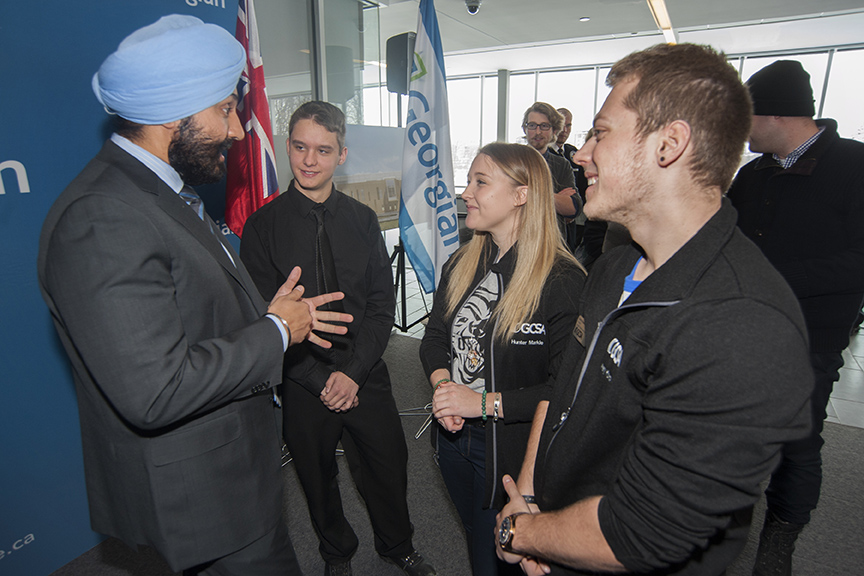 Navdeep Bains, Minister of Innovation, Science and Economic Development, chats with first-year Mechanical Engineering Technology student Mark Reckzin; Hunter Markle, Vice President, External Relations, Student Leadership and Transition Services, Georgian College Students? Association; and GCSA President Avery Konda.
