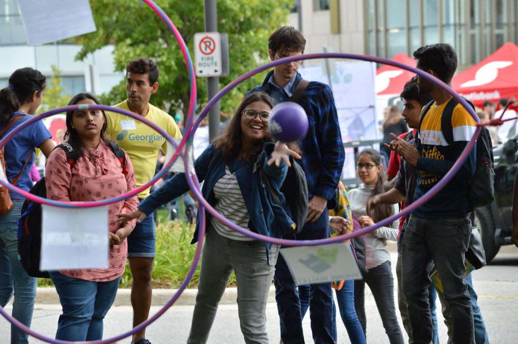 Students playing a hoop game