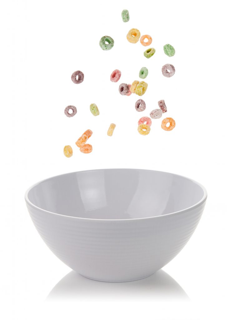 Cereal falling into a white bowl
