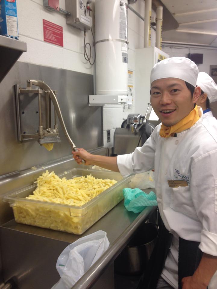 Kenta as a student working in a hospitality lab