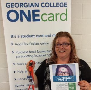 Social Service Worker student Kimberley DuGuerre holds her $500 ONEcard prize for winning the Office of the Registrar's you name it content to rename the college's new acdemic planning tools