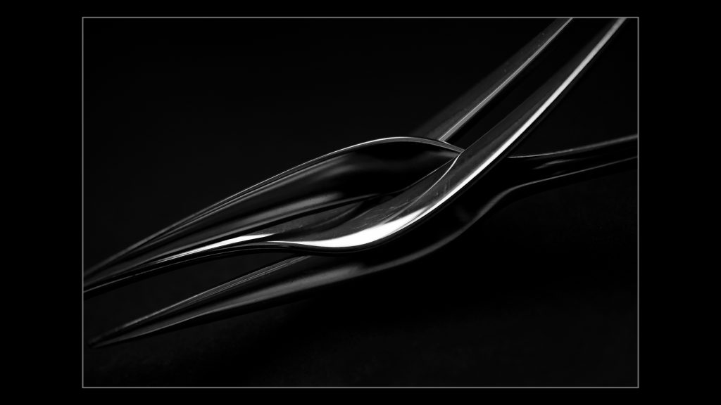 Sleek metal object on a black background