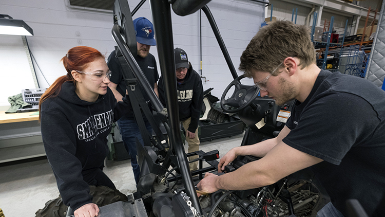 Male-and-female-Mechanical-Techniques-Marine-Engine-Mechanic-students-work-on-an-engine-in-Skilled-Trades-Centre