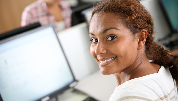 woman smiling while on the computer