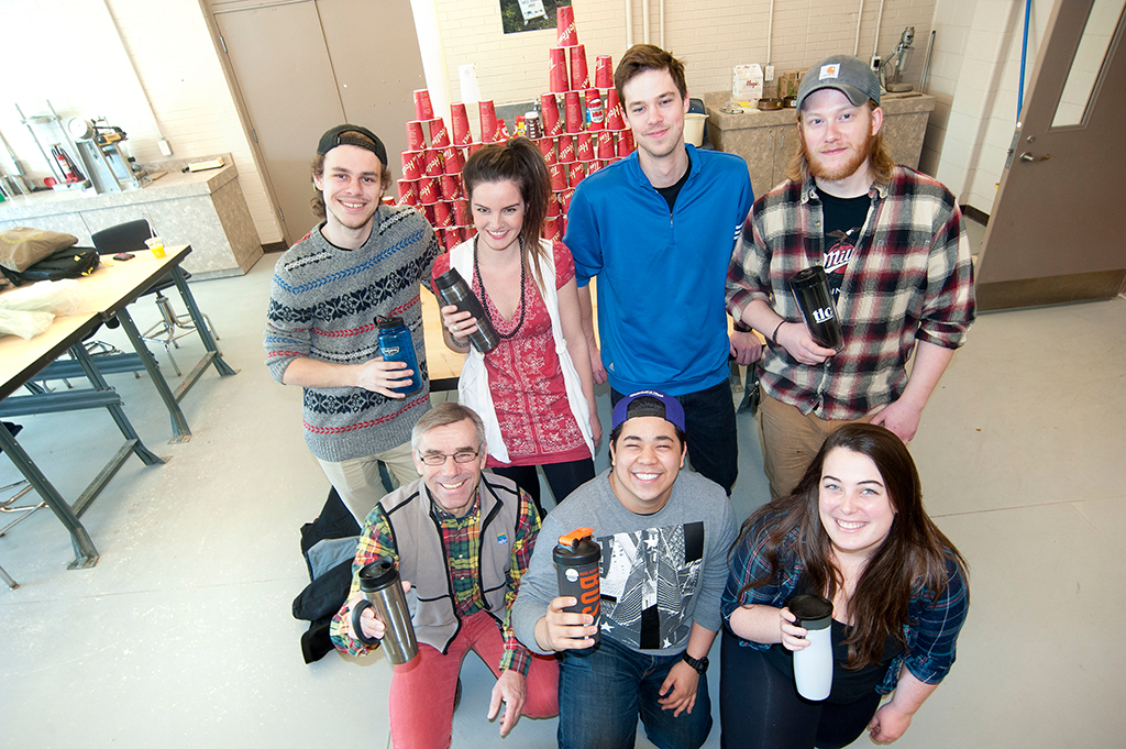 Students and members of GEAR next to paper cups