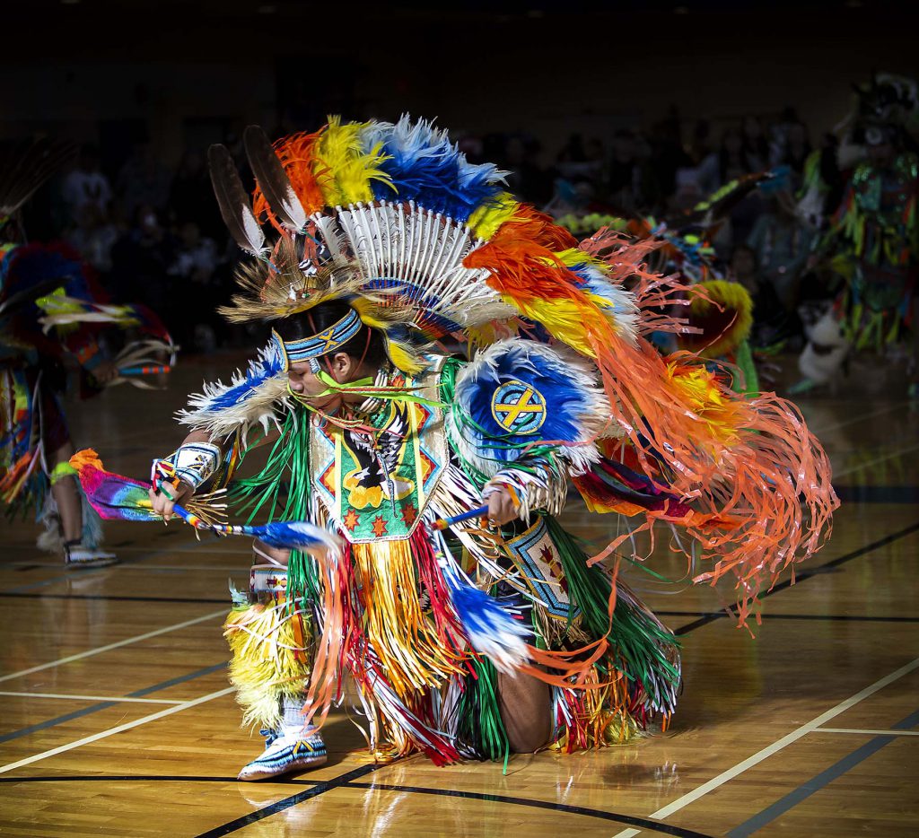 An Indigenous dancer at Pow Wow in traditional clothing
