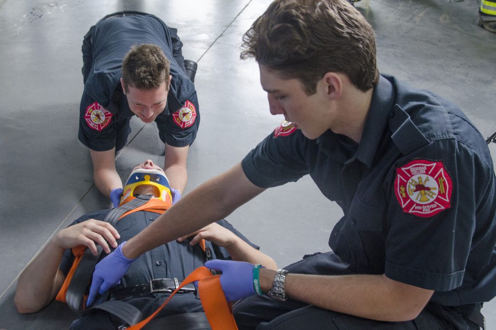 2 pre-service firefighter students performing first aid