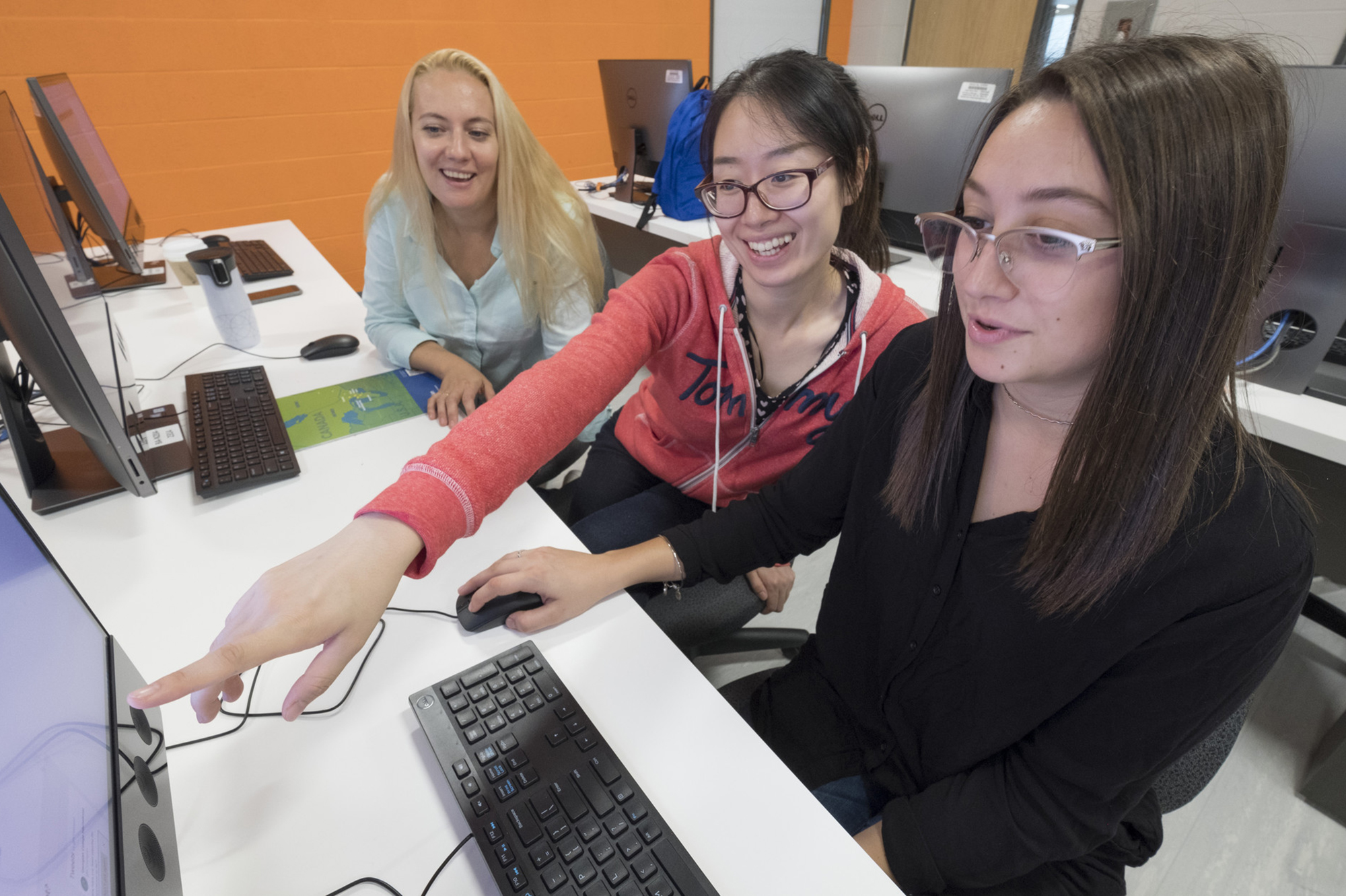 Three female students working on the computer