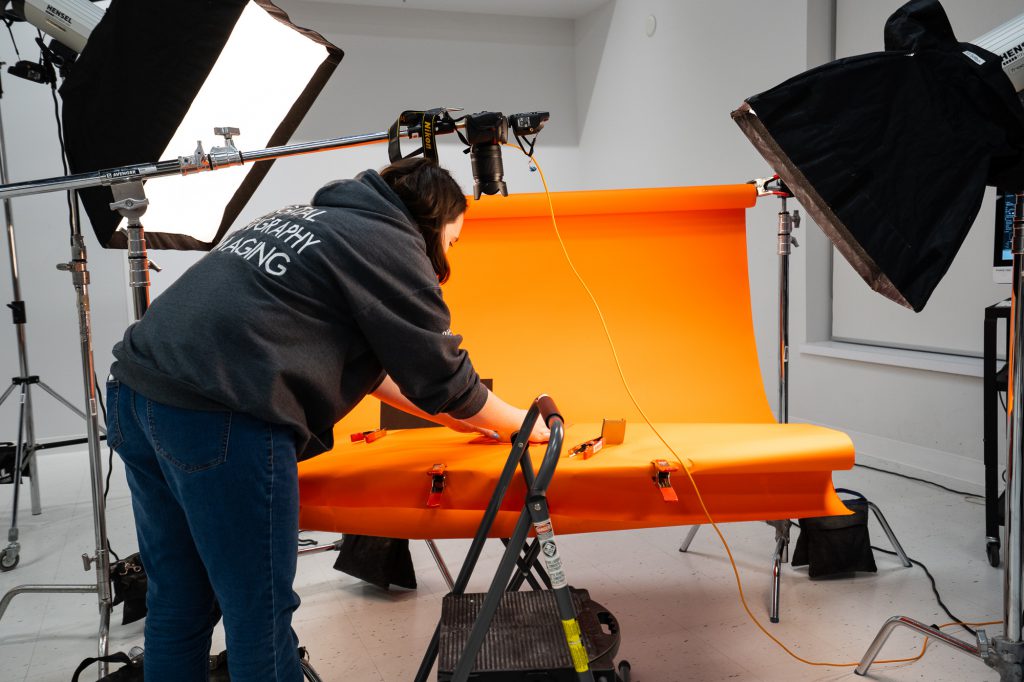a female student setting up photo shoot in the studio
