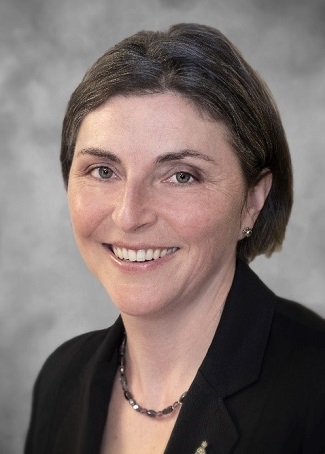 Head shot of Dr. Rebecca Sabourin, Associate Dean, woman with short hair chin length, black jacket, necklace with beads and warm smile