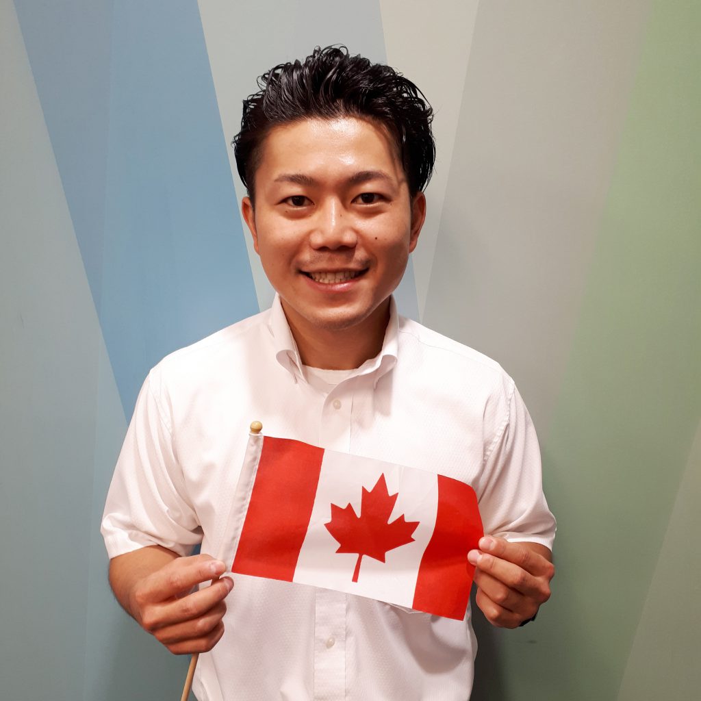 Kenta holding a Canadian flag