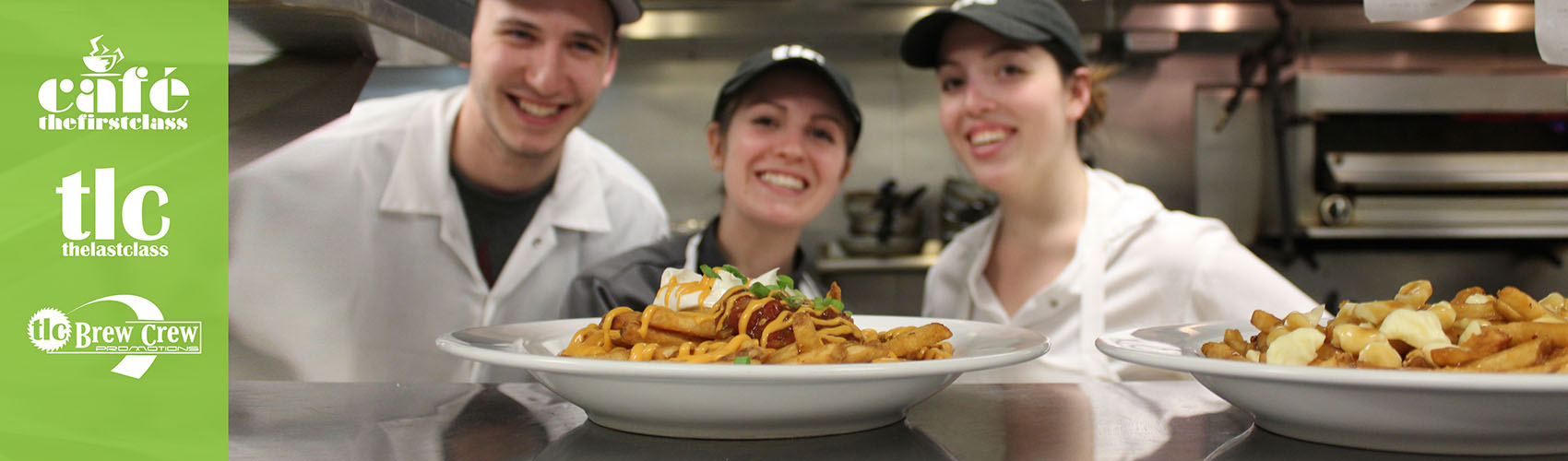 Three chefs in a kitchen, serving up plates of poutine