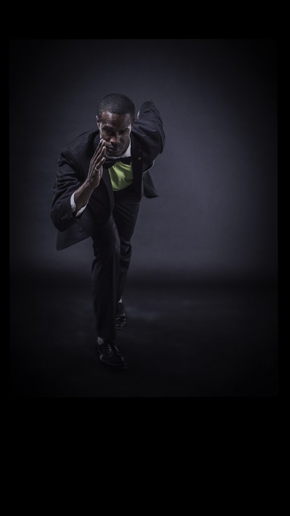 Man in a suit in a running position on a black background