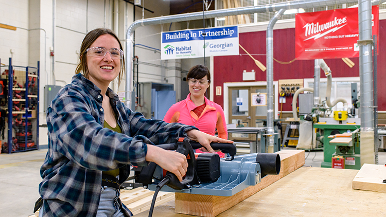 Two-female-construction-trades-pre-apprenticeship-students-work-in-state-of-the-art-shop-space