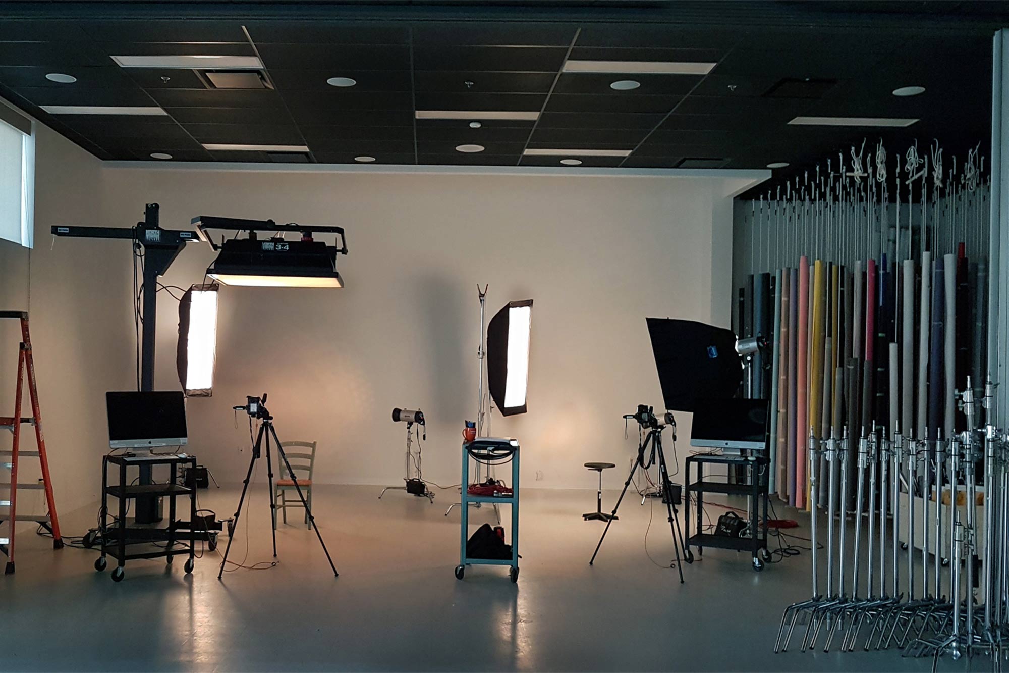 photography studio featuring camera and computer equipment, lighting, tripods, backdrops and more