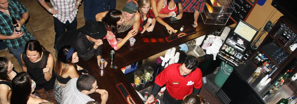 A crowd of students standing at the bar of The Den at the Orillia Campus