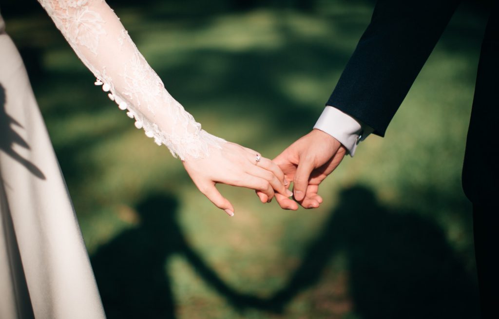 man and woman holding hands