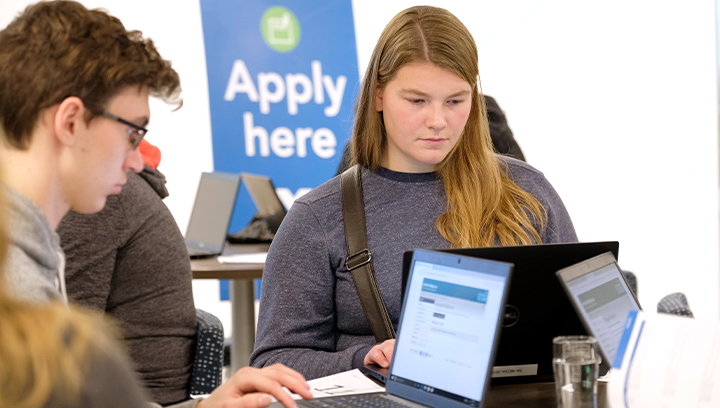 Students at Open House at the Applications Hub at the Barrie Campus using laptops to apply to Georgian for free