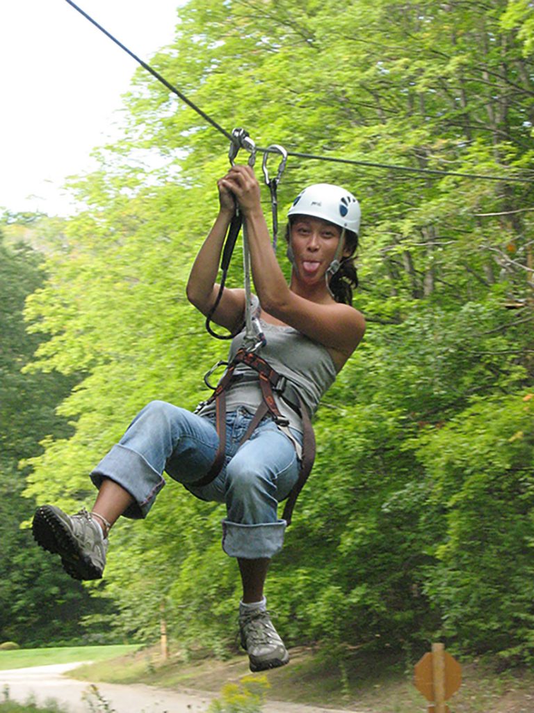 girl ziplining and sticking her tongue out