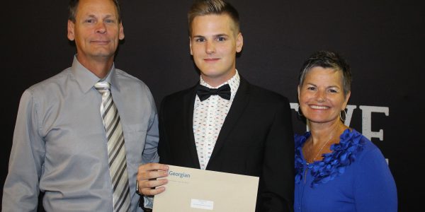 Jonathan, an Automotive Business School of Canada student, receiving an award