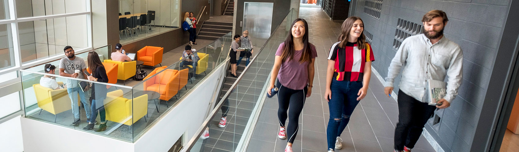 A group of three students walking through N Building at the Georgian College Barrie Campus