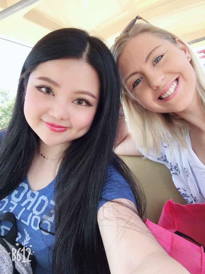 Two young woman, smiling, taking a selfie