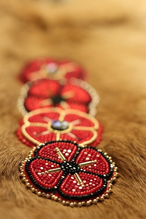 Red, black and gold beaded poppies for Indigenous Veterans Day.