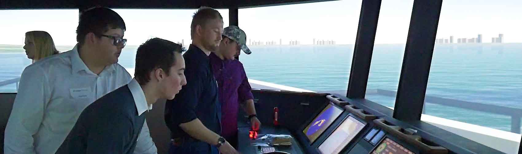 Students working in a commercial ship navigation simulator