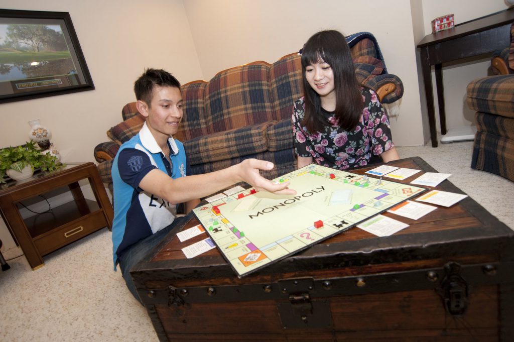 Two homestay students playing monopoly