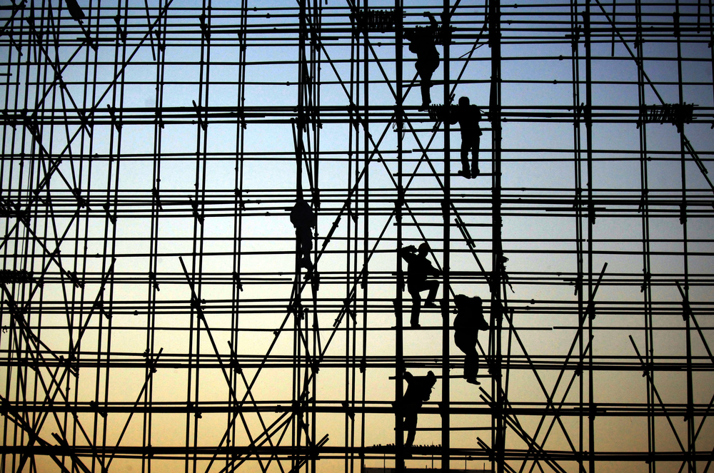 Silhouette of people on a scaffold