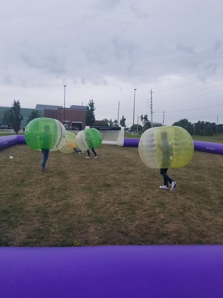a group of students playing zorb soccer during fall 2019 orientation at Georgian's South Georgian Bay Campus