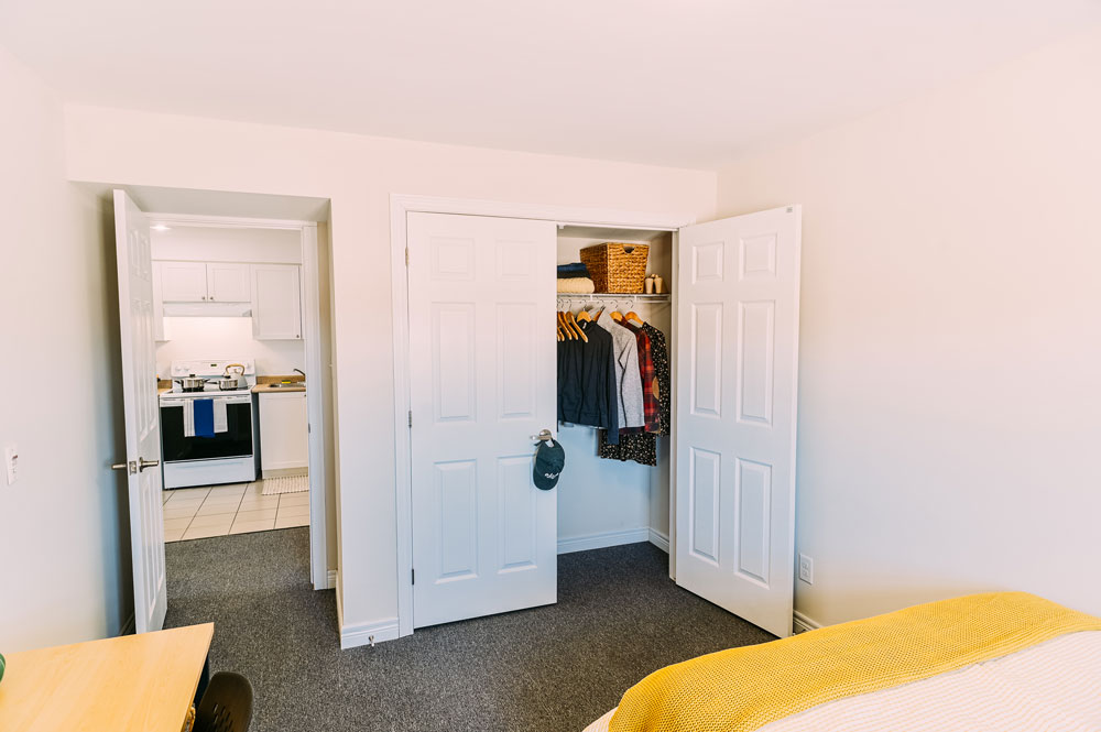 Closet and doorway of an Orillia Residence student bedroom overlooking the kitchen